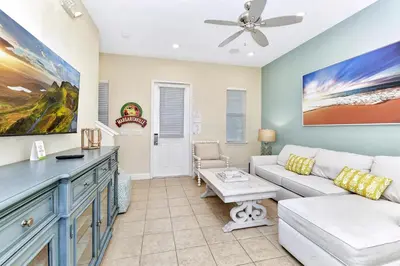 a living room with a couch and a ceiling fan at Casa Blanca Cottage With Hot Tub Near Disney With Margaritaville Resort & Island H2O Access - 8032Su in Orlando