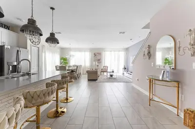a kitchen with a counter and chairs in a room at 5 BR Disney themed bedrooms SL 4825 in Kissimmee