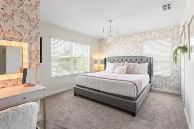 a bedroom with a bed and a dresser and a mirror at 5 BR Disney themed bedrooms SL 4825 in Kissimmee