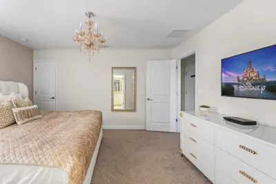 a bedroom with a bed and a tv on the wall at 5 BR Disney themed bedrooms SL 4825 in Kissimmee