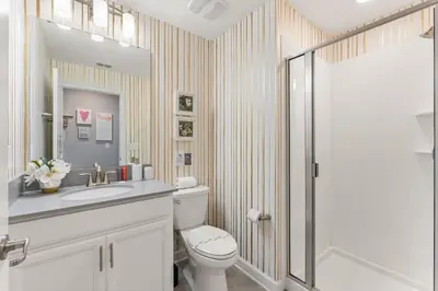 a bathroom with a toilet and a sink and a shower at 5 BR Disney themed bedrooms SL 4825 in Kissimmee