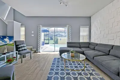 a living room with a couch and a table at Encantada Resort: Pool, Gym, Clubhouse, Near Disney in Kissimmee