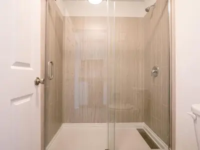 a shower with a glass door in a bathroom at Fun filled 1BR Close to Disney Parks With Lake view in Vineland