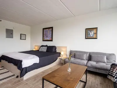 a bedroom with a bed and a couch at Relax & Enjoy 1BR Home Near Disney Parks With Lake view in Kissimmee