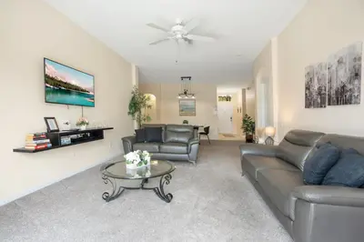 a living room with a couch and a table at Relaxing Retreat in the Windsor Palms Resort in Kissimmee