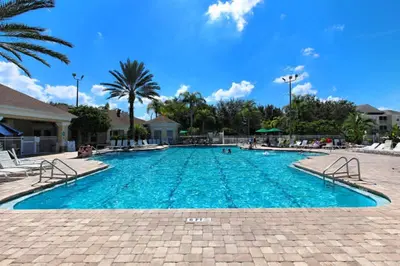 a swimming pool with blue water in a resort at Relaxing Retreat in the Windsor Palms Resort in Kissimmee
