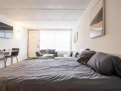 a large bed in a room with a large window at Delightful 1BR Condo Next to Disney With Lake view in Vineland