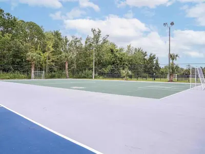 a tennis court with a net on it at Lovely 1BR Suite Minutes to Disney With Lake view in Vineland