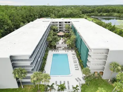 an aerial view of a building with a swimming pool at Elegant 1BR Haven in Orlando & 5 minutes to Disney in Vineland