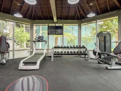 a gym with treadmills and machines in a room at Elegant 1BR Haven in Orlando & 5 minutes to Disney in Vineland