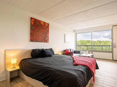 a bedroom with a large bed and a large window at Orlando Prime Location 1BR Home 5 minutes to Disney in Kissimmee