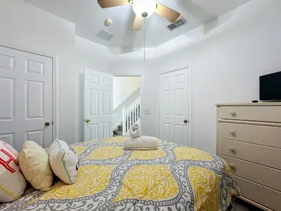 a bedroom with a bed and a ceiling fan at 3BR Disney Getaway, Pool, Waterslides, By Disney in Orlando