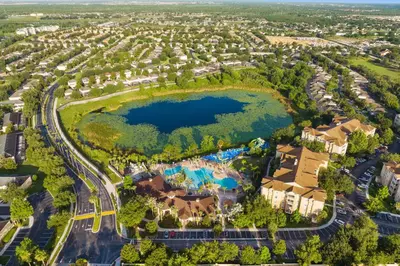 an aerial view of a resort with a lake at 3BR Disney Getaway, Pool, Waterslides, By Disney in Orlando