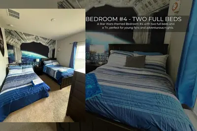 two beds in a bedroom with a painting on the wall at Spacious 4-Bedroom Family Retreat Near Disneyland! in Kissimmee