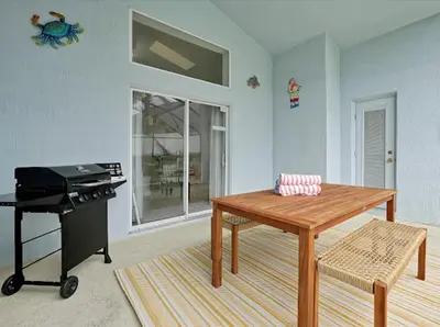 a living room with a table and a piano at 6BD - Pool, BBQ & Movie Theater - 10 Mins to Disney in Kissimmee