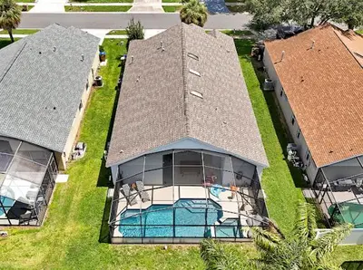 an aerial view of a house with a swimming pool at 6BD - Pool, BBQ & Movie Theater - 10 Mins to Disney in Kissimmee
