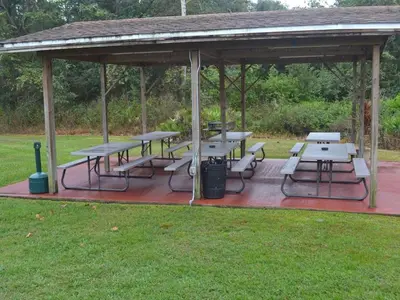 a picnic shelter with tables and benches in a park at 2492 Your home away from Home in Kissimmee