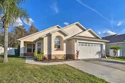 a house with a palm tree in front of it at 4 Bed Villa in Kissimmee, Orlando in Kissimmee