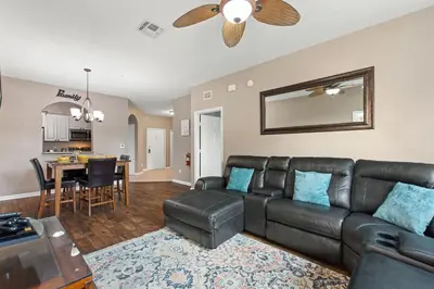 a living room with a leather couch and a table at Condo in Gated Windsor Hills in Orlando