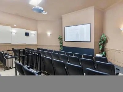 a conference room with black chairs and a projection screen at Condo in Gated Windsor Hills in Orlando