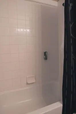 a white bathroom with a white tub and a shower at 4 Bed Villa - Eagle Pointe - Kissimmee in Kissimmee