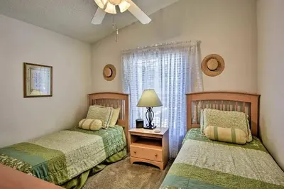 a bedroom with two beds and a window at 4 Bedroom Villa - Indian Creek in Kissimmee