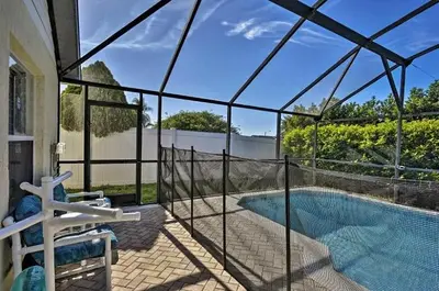 a house with a swimming pool with a fence around it at 4 Bedroom Villa - Indian Creek in Kissimmee