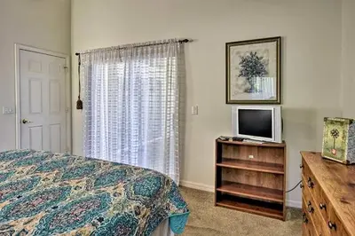 a bedroom with a bed and a television on a dresser at 4 Bedroom Villa - Indian Creek in Kissimmee