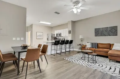 a living room with a couch and a table at Casa 3Q Windsor Hills c/ Piscina Perto da Disney in Orlando
