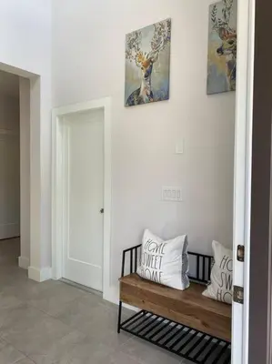 a hallway with a wooden bench with pillows on it at beautiful home in Kissimmee