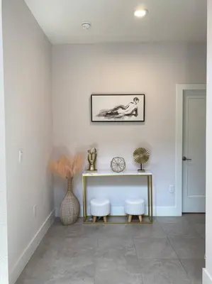 a living room with a table and two stools at beautiful home in Kissimmee