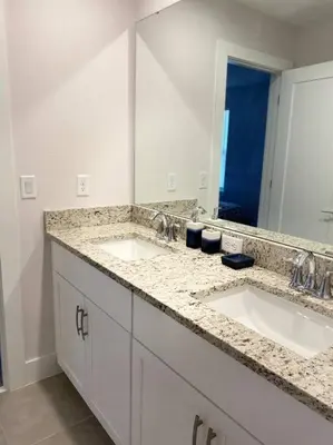 a bathroom with two sinks and a large mirror at beautiful home in Kissimmee