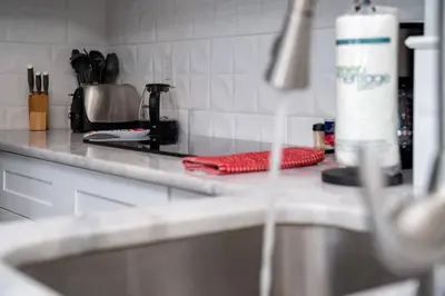 a kitchen counter with a sink and a stove at Apartment in Florida near Universal and Intern. Dr in Orlando