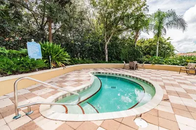 a small swimming pool in a patio with a sign at Casa 3Q Resort + Jacuzzi Perto Disney in Kissimmee