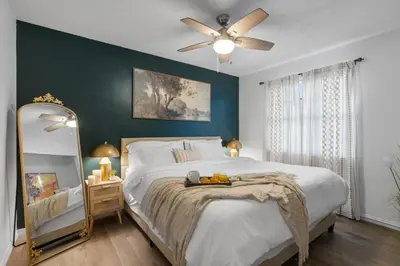 a bedroom with a large bed with a ceiling fan at Fantasy Villas resort - Waterpark Included - Family Paradise! minutes to Disney in Kissimmee
