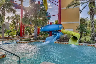 a water slide in a pool at a resort at Fantasy Villas resort - Waterpark Included - Family Paradise! minutes to Disney in Kissimmee