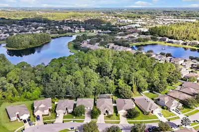 an aerial view of a home with a lake at Entire home w/ Private Pool,Gated Near Disney in Orlando