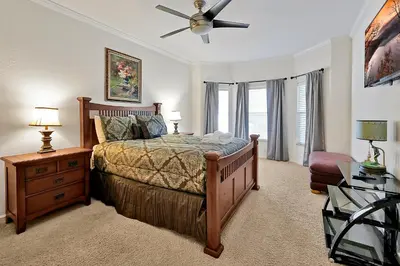 a bedroom with a bed and a ceiling fan at Entire home w/ Private Pool,Gated Near Disney in Orlando