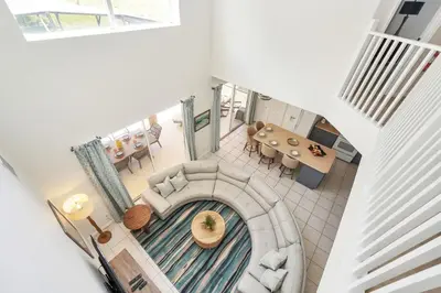 an overhead view of a living room with a spiral staircase at Family Villa with Private Pool Game Room & Themed Rooms in Kissimmee