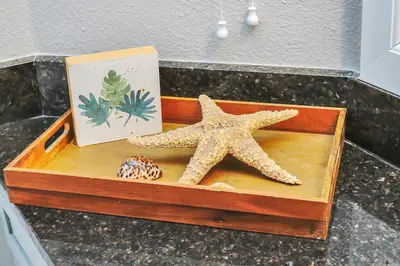 a wooden box with two starfish and a book at Family Oasis Cozy Retreat with Bunk Room in Kissimmee
