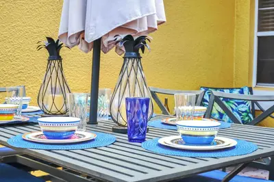 a table with three vases and plates on it at Family Oasis Cozy Retreat with Bunk Room in Kissimmee
