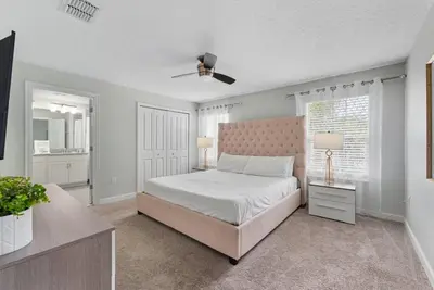 a bedroom with a bed and a ceiling fan at Casa de Luxo em Storey Lake Resort in Kissimmee