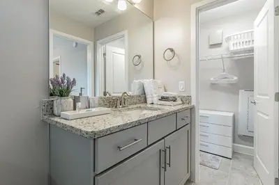 a bathroom with a sink and a large mirror at 3Q/2.5B *Ótima Localização* in Kissimmee