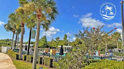 a group of palm trees in a park with a sign at Deluxe Villas Resort at Seven Dwrafs - Close to Disney in Kissimmee