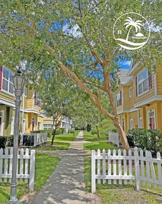 a white fence in front of a row of houses at Deluxe Villas Resort at Seven Dwrafs - Close to Disney in Kissimmee