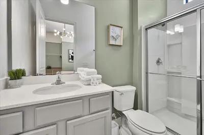 a bathroom with a toilet and a sink and a shower at Gorgeous Paradiso Mansion-Poolgame Roomtheater-3 in Orlando