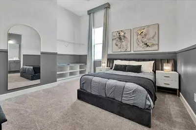 a bedroom with a large bed and a mirror at Gorgeous Paradiso Mansion-Poolgame Roomtheater-3 in Orlando