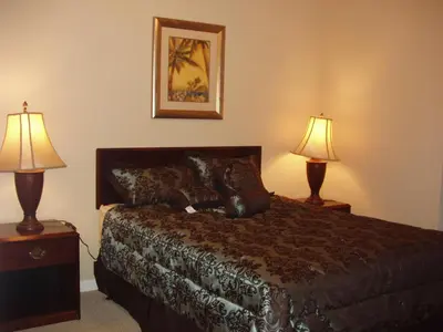 a hotel room with a bed and two lamps at Four Bedroom Villa in Coral Cay in Kissimmee