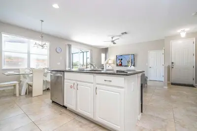 a kitchen with a sink and a counter top at 4BR Lakefront - Themed Rooms - Pool & BBQ! in Kissimmee