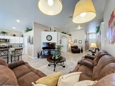 a living room with a couch and a table at 4 Bed in Windsor Palms Resort - Steps to Disney villa in Kissimmee